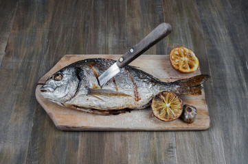 Grilled fish on the wooden table