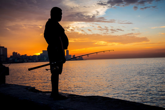 Man Fishing At Malecon,  In Havana, Cuba.