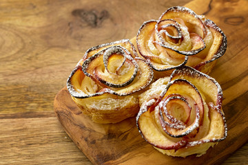 apple shaped rose dessert on wooden table