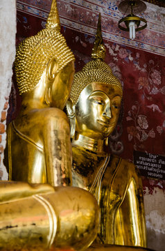 Gild Buddha Sculpture at Ancient Veranda of Wat Suthat, Bangkok of Thailand.