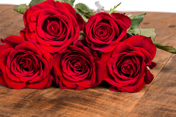 Red roses on a wooden table