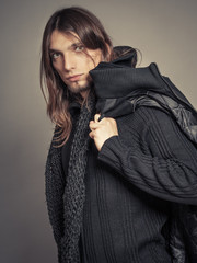 Handsome fashion man portrait wearing black coat.