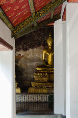 Gild Buddha Sculpture at Ancient Veranda of Wat Suthat, Bangkok of Thailand.