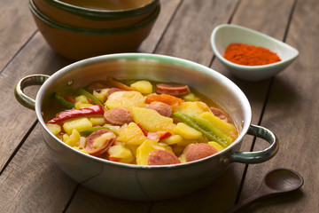 Hungarian dish called Paprikas Krumpli (Potato with Paprika), a stew made of potato, onion, pepper, tomato, sausage, seasoned with Hungarian paprika (Selective Focus, Focus in middle of dish)