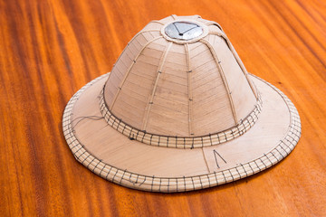 Fototapeta na wymiar Bamboo sheath hat on wood furniture