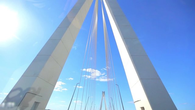 moving on car across bridge on blue sky background