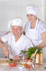 Elderly couple cooking