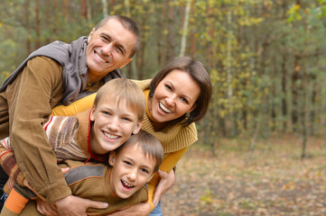 Happy family in autumn forest