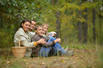 Naklejka na ściany i meble Happy family in autumn forest
