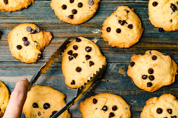 Selection of homemade chocolate chip cookies on wooden background