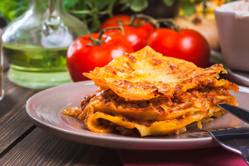 Piece of tasty hot lasagna on a plate