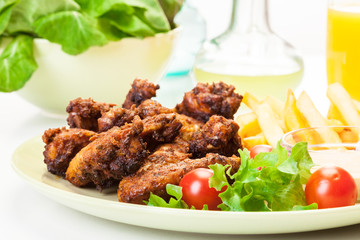 Chicken wings with fries french and spicy sauce