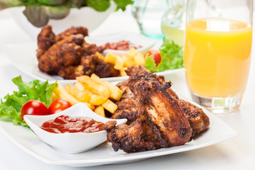 Chicken wings with fries french and spicy sauce