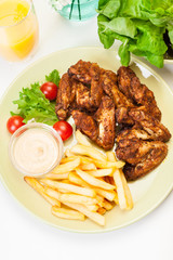 Chicken wings with fries french and spicy sauce