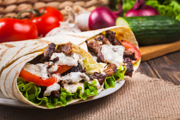 Tasty fresh wrap sandwich with beef and vegetables