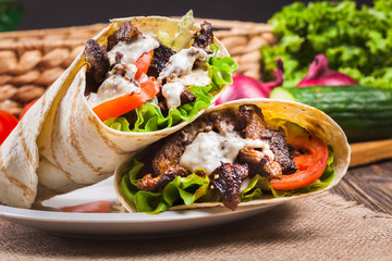 Tasty fresh wrap sandwich with beef and vegetables