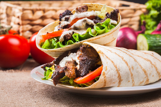 Tasty fresh wrap sandwich with beef and vegetables