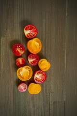 red yellow tomatoes sliced on a wooden board.