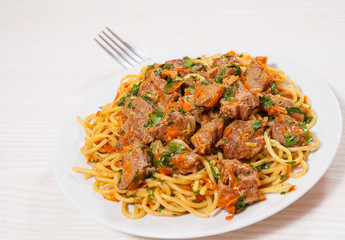 Pieces of meat and vegetables with spaghetti