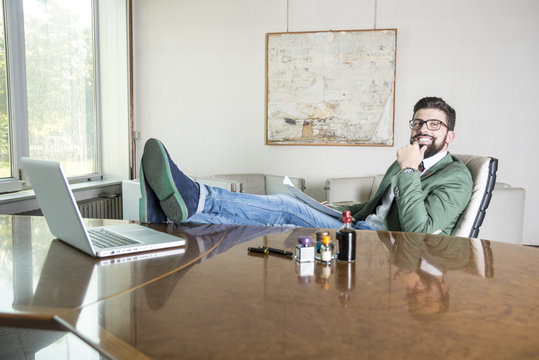 smiling hipster in his office