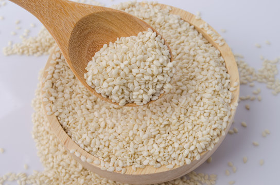 sesame seeds with wooden spoon