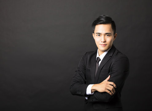 young asian businessman on black background
