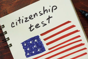 Notepad with words  citizenship test and American flag.