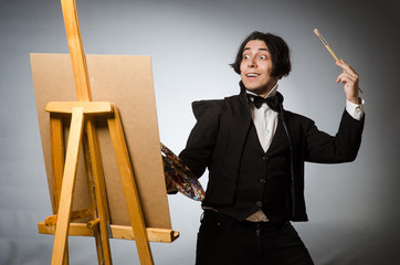 Funny artist in dark studio