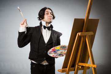 Funny artist in dark studio