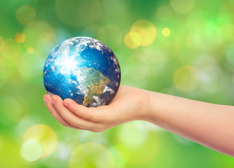 child holding earth in hand. save the earth concept.