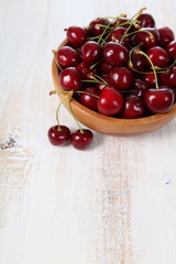 Ripe cherry in a wooden bowl