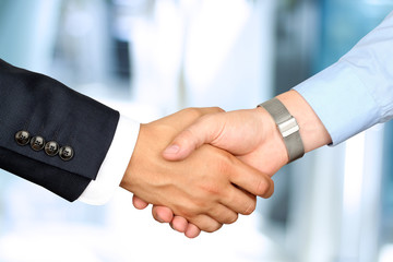 Close-up image of a firm handshake  between two colleagues
