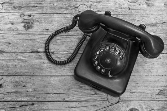 Old telephone on wooden background 