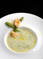 Delicious cream soup with asparagus and shrimp. Selective focus