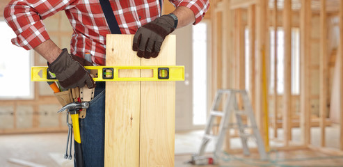 Handyman hands with wood plank.