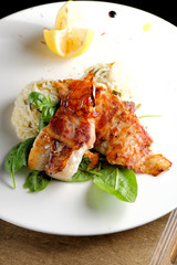 Fine dining, fish fillet breaded in herbs and spice on vegetable risotto.