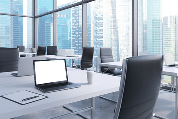 Fototapeta na wymiar Workplaces in a modern corner panoramic office with panoramic view of Singapore. White tables and black chairs. A laptop with a white screen, notepad and a coffee cup. 3D rendering.