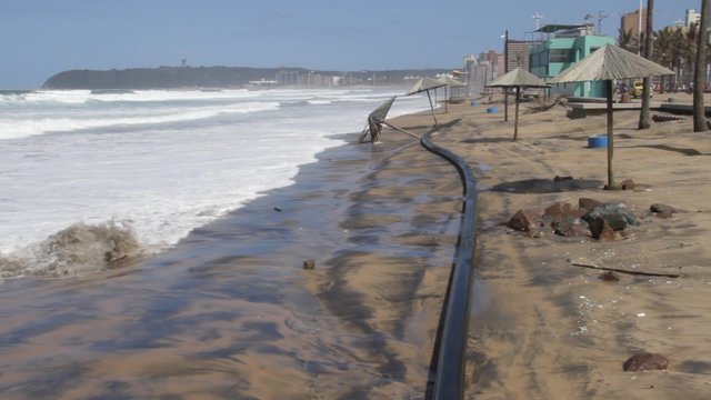 Rough seas causing beach erosion on Durban's beaches exposing pipes and knocking down beach umbrellas.