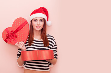 girl in Santa Claus hat with gift box