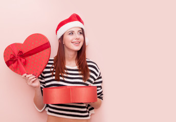 girl in Santa Claus hat with gift box