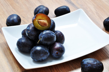 plums on a white platter