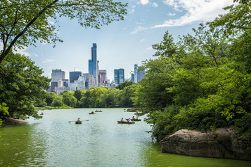 Lake in central park and New York city skyline.