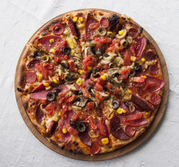 Delicious pizza served on wooden table