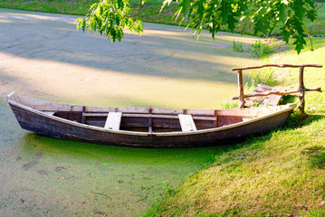 Wooden boat at the riverbank. Lithuania.