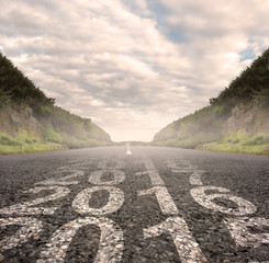 transition between year 2015 and year 2016 painted on asphalt road