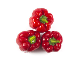 Three red sweet peppers isolated on white