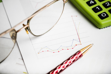 finance report wiht calculator and pen