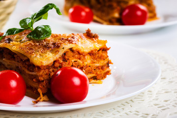 Piece of tasty hot lasagna with red wine..