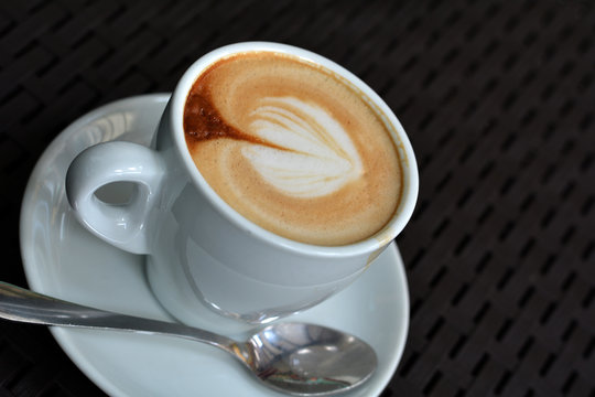 White Cup Of Foamy Cappuccino On A Black Background