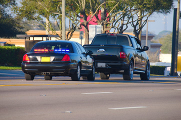 An unmarked police car has pulled over a truck for a traffic violation - obrazy, fototapety, plakaty
